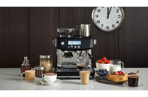 Breville Barista Pro Black Truffle espresso machine with portafilter and milk jug"
